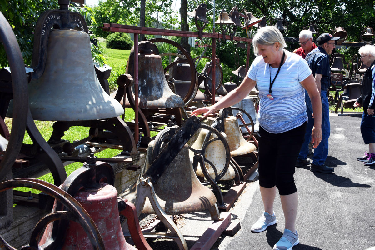 189 Linda Strotman explores the sounds of the various bells.JPG